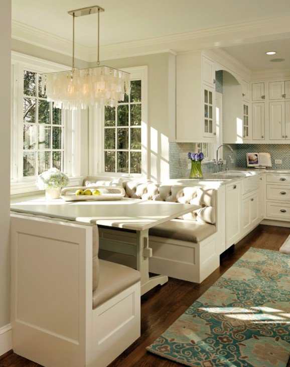 Tufted kitchen banquette with capiz chandelier and farmhouse sink