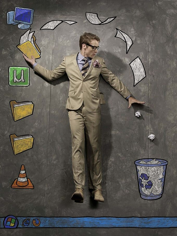 Man in a suit interacting with chalk computer desktop icons and recycle bin