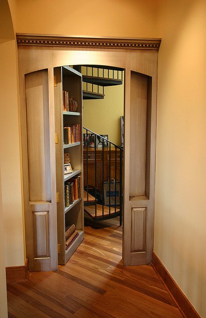 Secret door bookshelf opening to a spiral stair
