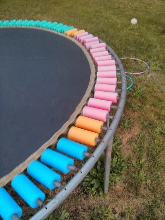Kids playing with pool noodles outdoors
