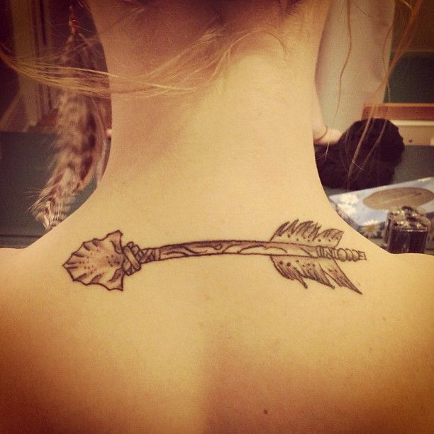 Symmetric arrow tattoo design
