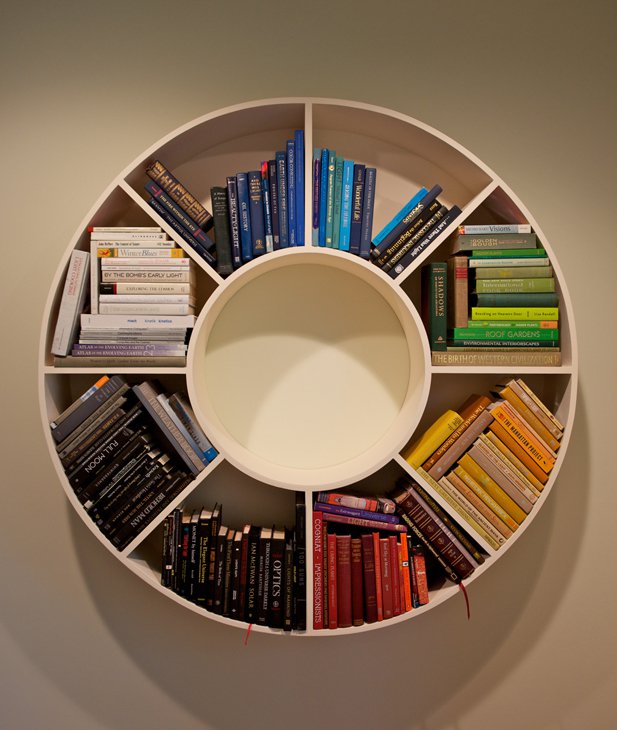 Circular wall bookshelf arranged as a color wheel
