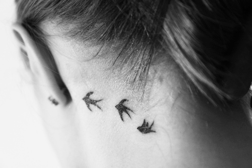 three bird silhouettes tattoo behind the ear