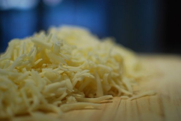 Brandon-Matzek-food-photography04 Shallow-focus pile of freshly shredded cheese on wood