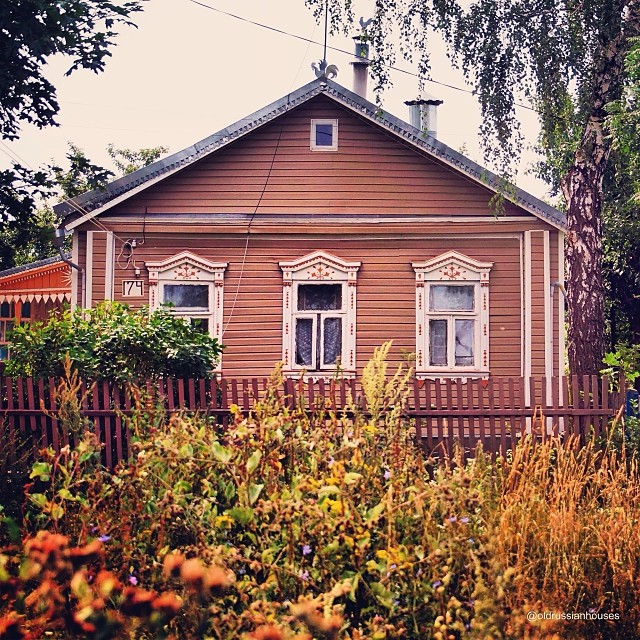 Old wooden house with painted shutters and trim