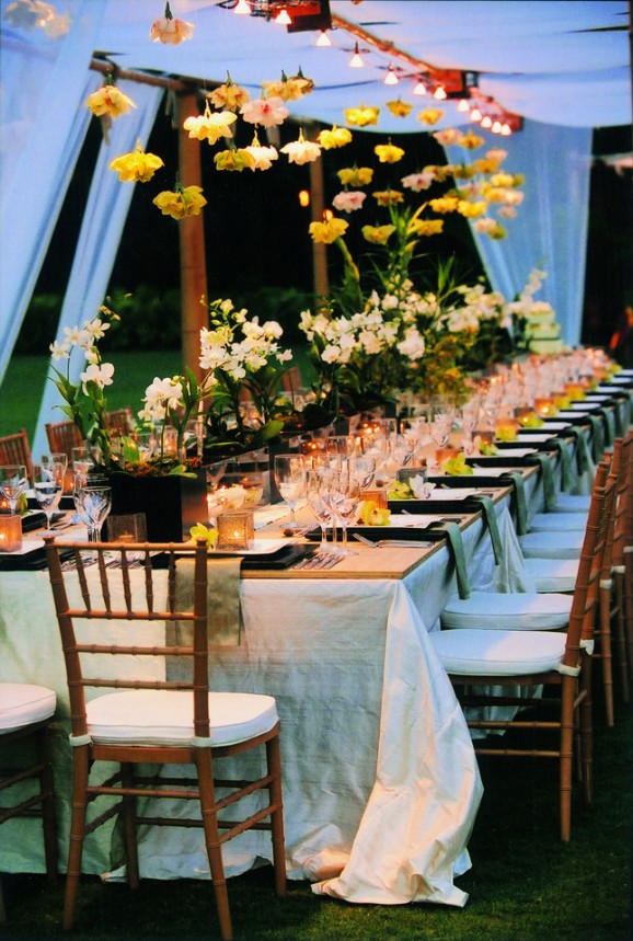 Outdoor night table with hanging blooms and string lights