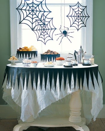 Black and white Halloween dessert buffet with spiderweb decor