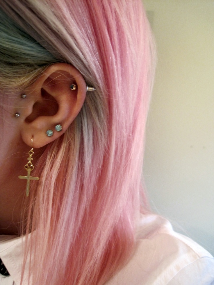 multiple piercings with cross dangle and pastel hair