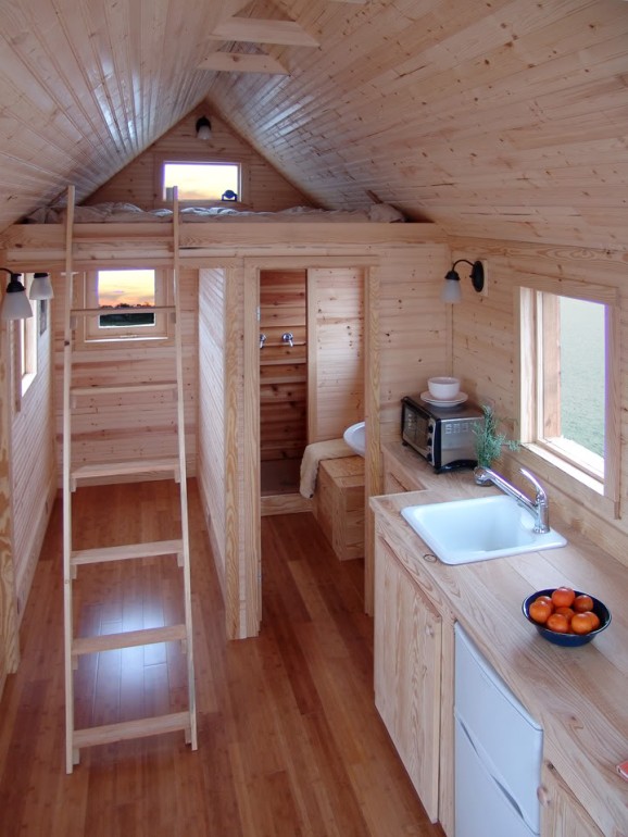 Compact wood tiny-house interior with loft