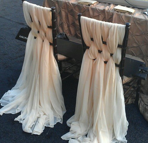 Wedding chairs in a decorated aisle