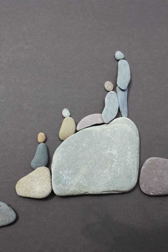 Group of four pebble figures on rocks