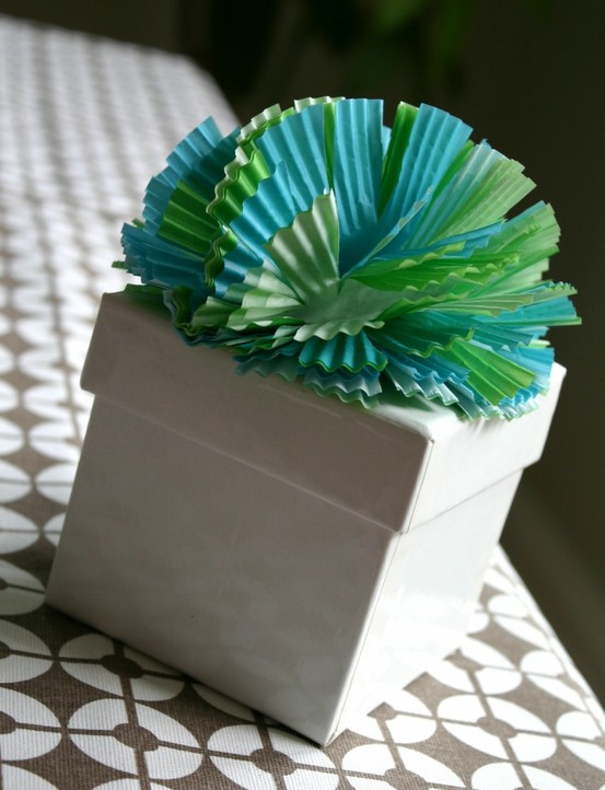 Cupcake liners stapled in the middle, then cut petals to make a gift topper bow