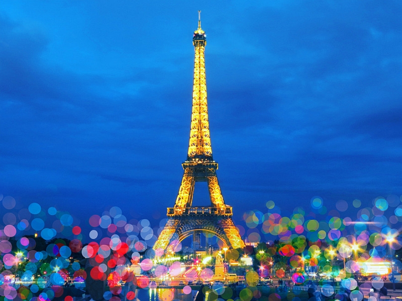 Golden Eiffel Tower at blue hour with colorful foreground bokeh