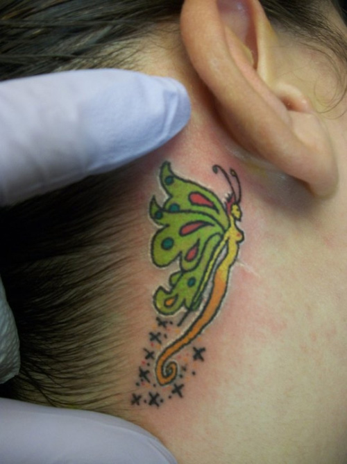 colorful fairy tattoo behind the ear