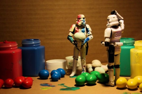Paint-covered stormtrooper beside jars, candies, and a confused partner