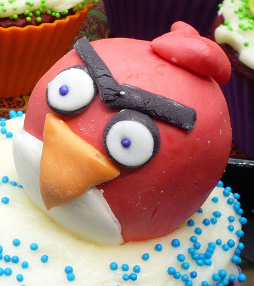 Angry Birds red character cupcake with blue sprinkles