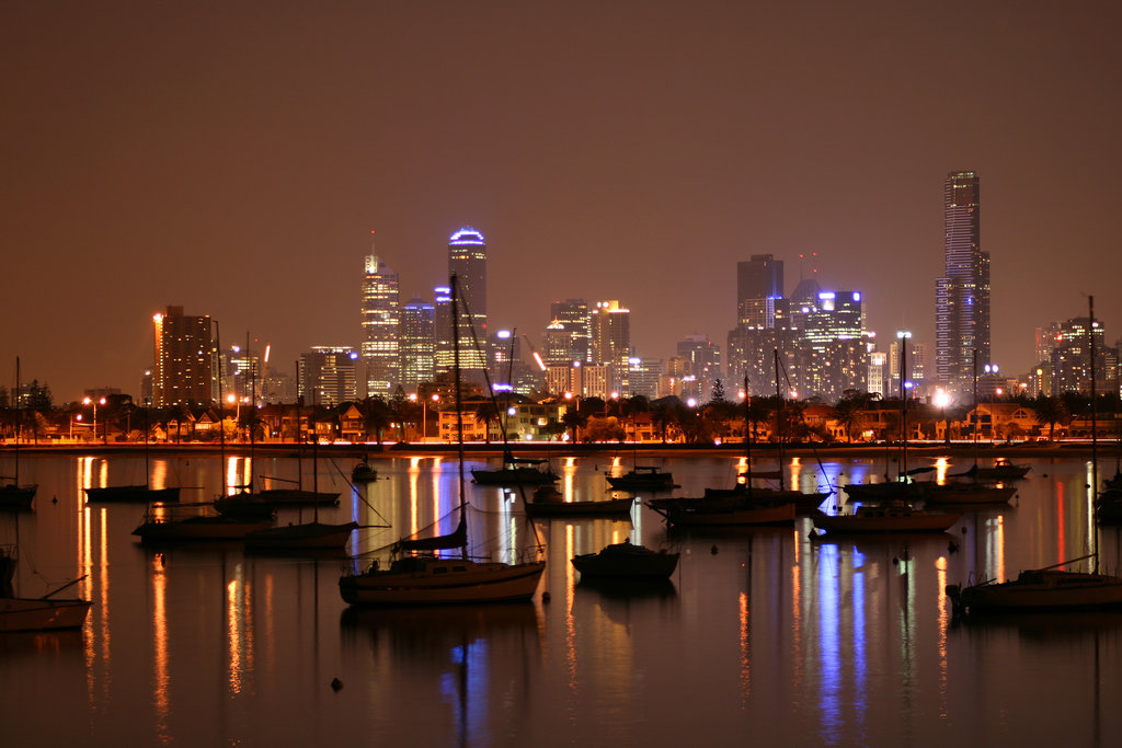 monteycarlos Coastal city lights at night along a curved shoreline