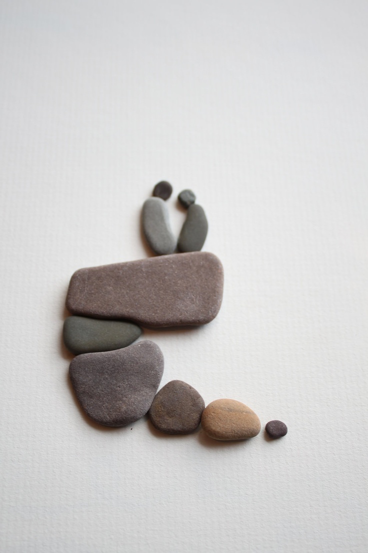 Two figures sitting on a pebble outcrop