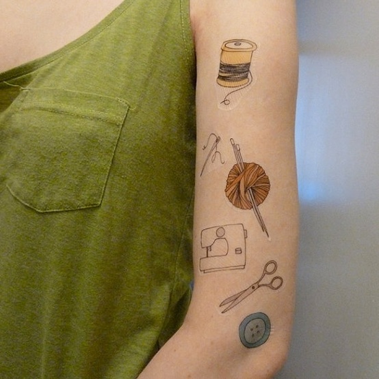 Vertical row of craft tattoos including spool, needle, yarn, sewing machine, scissors, and button
