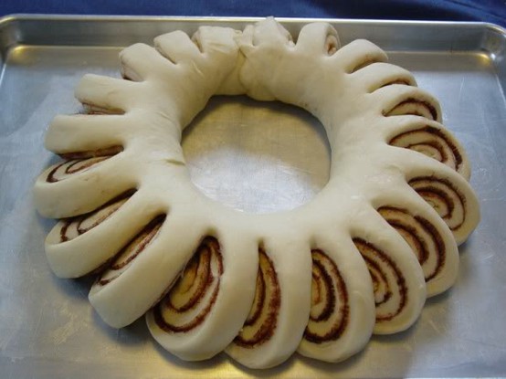 Christmas cinnamon roll wreath with frosting in the center