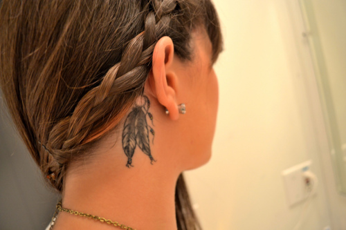 two feathers hanging tattoo behind the ear