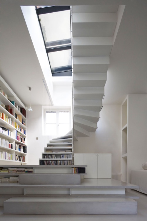 White staircase with books stored under wide lower steps
