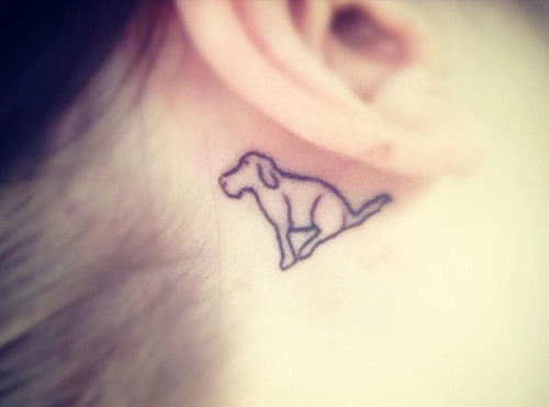 minimalist running dog tattoo behind the ear