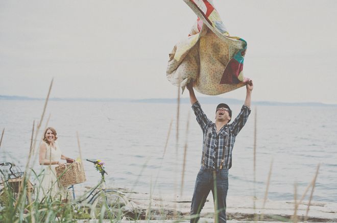Picnic engagement photo with basket and blanket