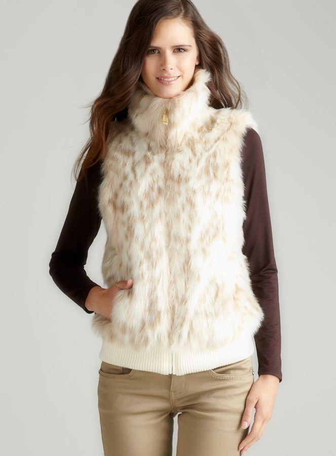 Long knit vest layered over a blouse