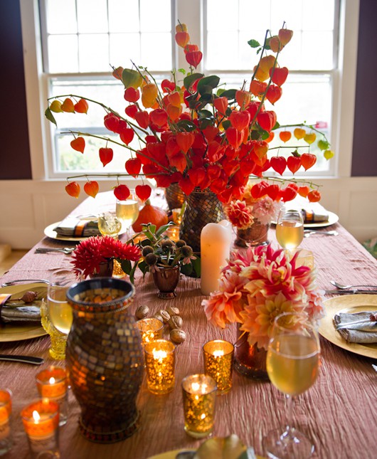 Autumn table with candles and greenery