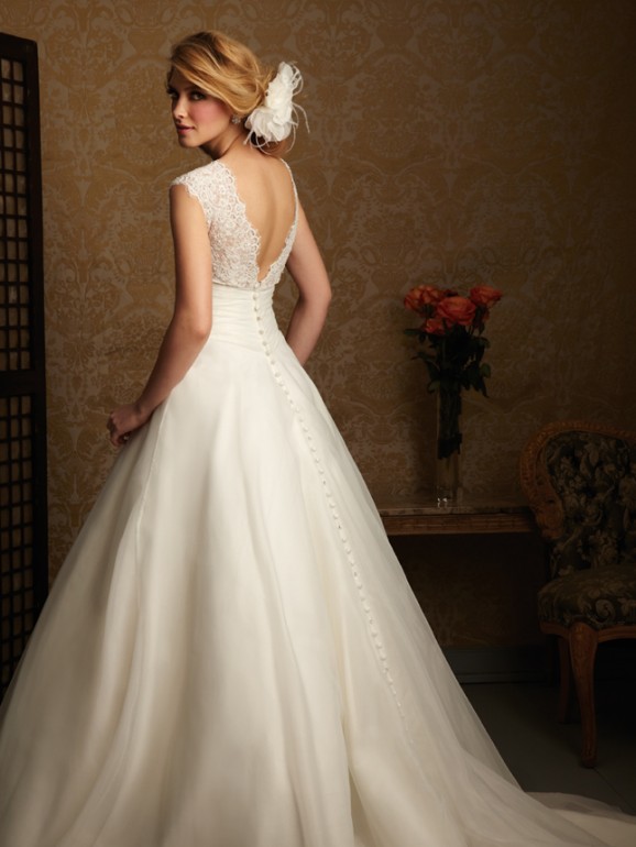 Lace-strap gown with buttoned train and floral hairpiece