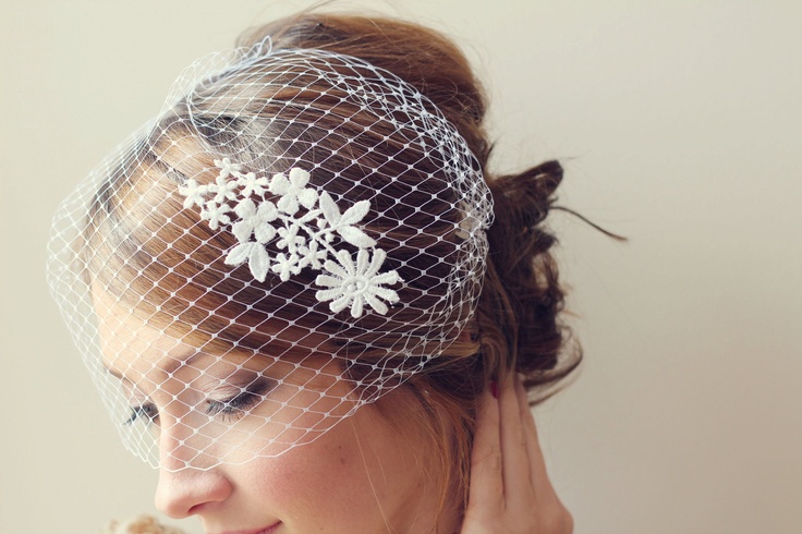 Birdcage veil styled with an updo and classic bridal makeup