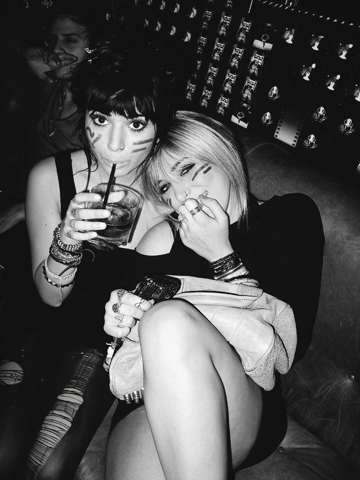 Friends sharing a night out on a tufted couch