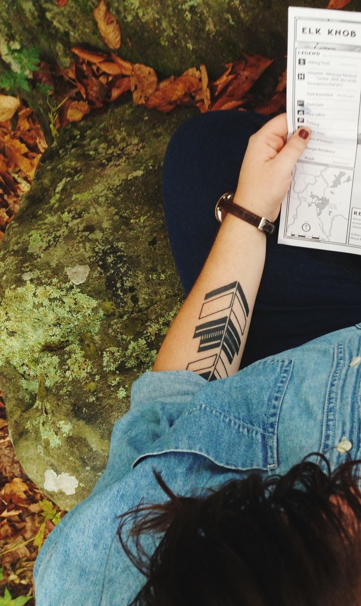Detailed arrow and bow tattoo