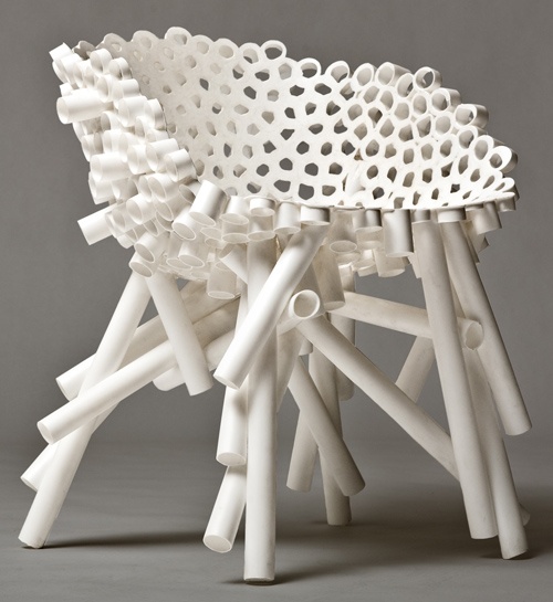 White chair built from cylindrical tubes in a cellular shell