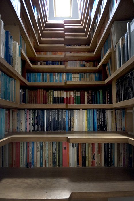 Looking up a stairwell lined entirely with bookshelves