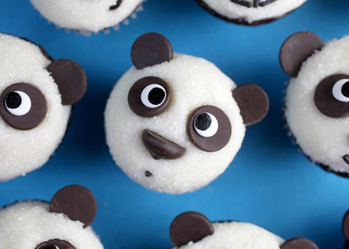 Panda face cupcakes with chocolate ears and coconut fur