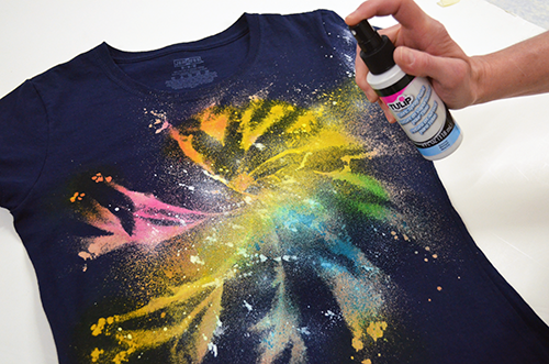 Galaxy-style fabric spray paint design on a navy T-shirt