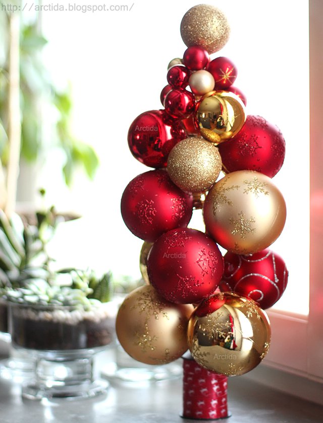 tabletop Christmas tree made of red and gold ornaments