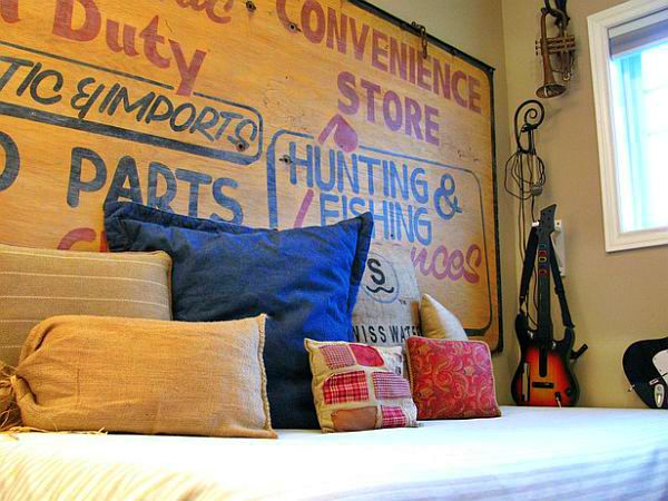 Vintage wooden sign used as a rustic headboard