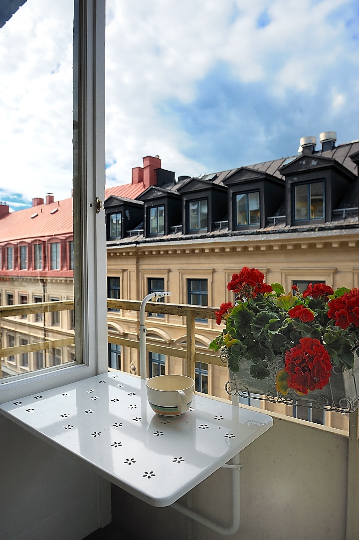 Cozy balcony lounge with textiles