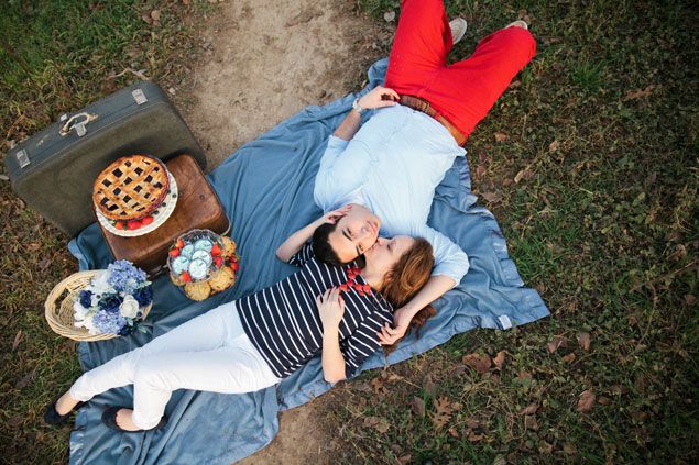 Couple reclining on a picnic blanket