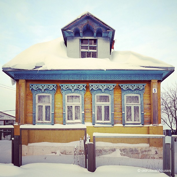 Wooden house façade with decorative window frames