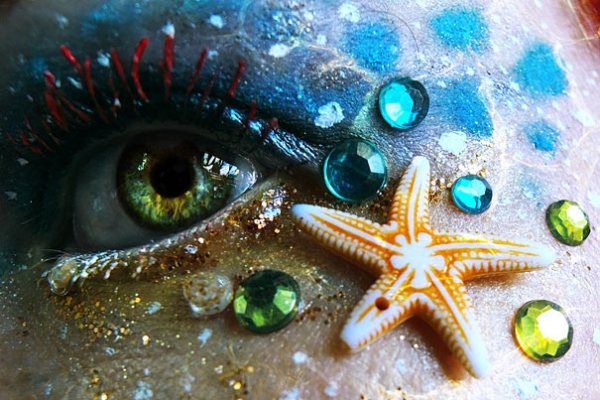 Nautical eye makeup with starfish charm, rhinestones, and gold glitter