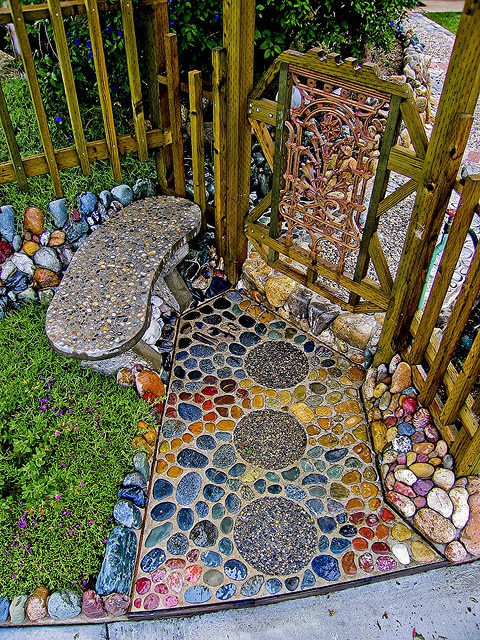 Pebble mosaic garden path and stone bench