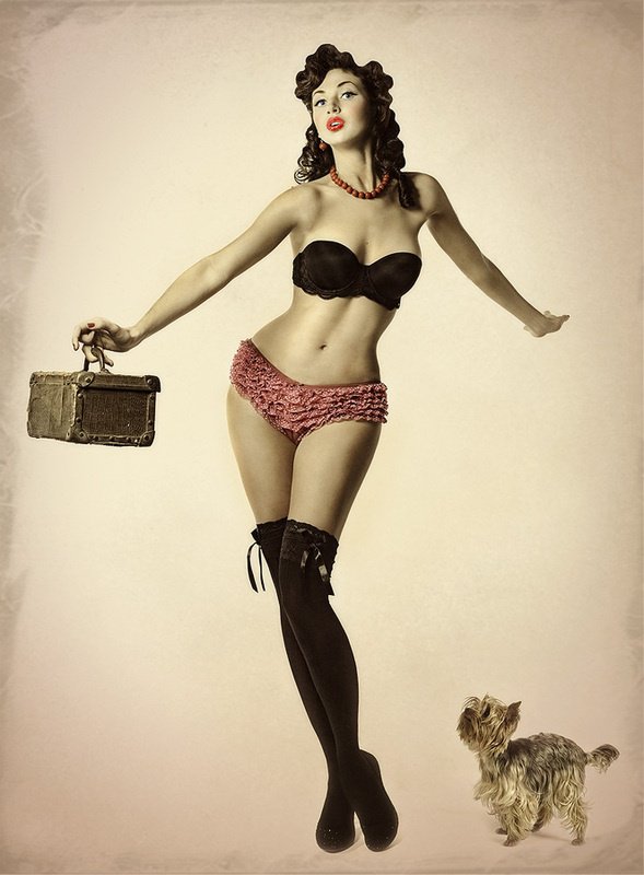 Pin-up themed boudoir photograph with playful expression