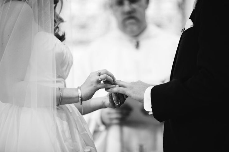 Couple in black and white against architectural backdrop
