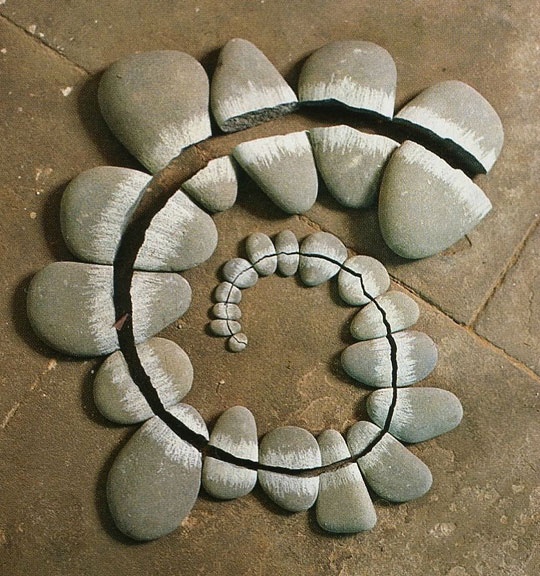 Spiral of split pebbles on a stone floor