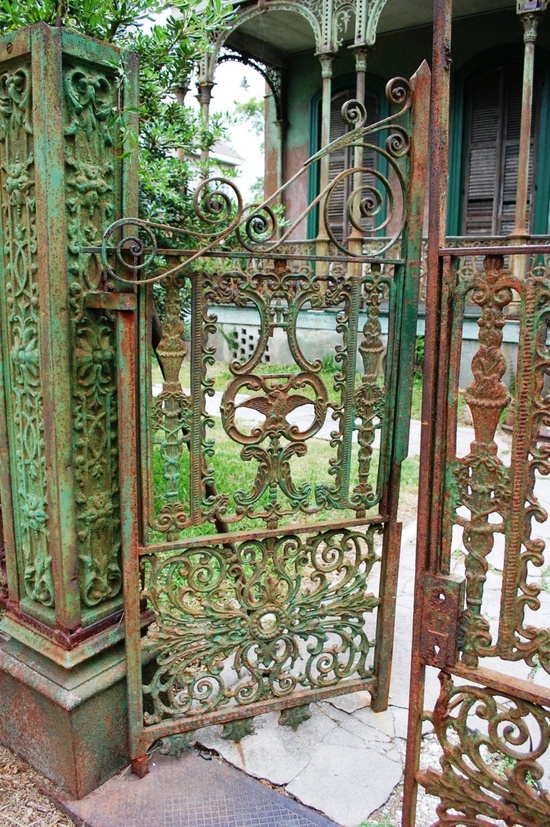 Garden gate framed by dense planting