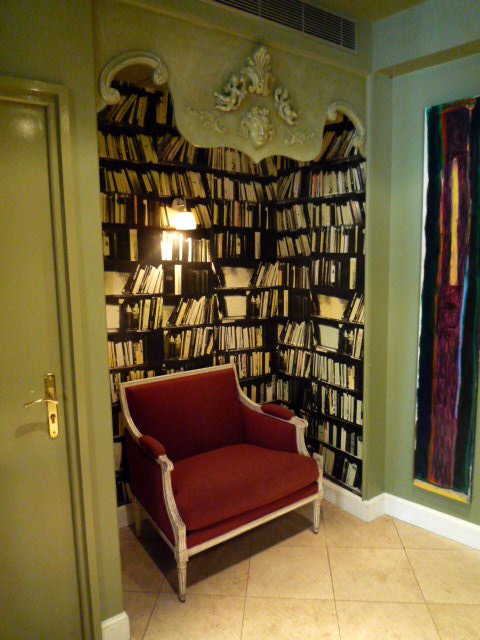 Corner alcove library with red armchair